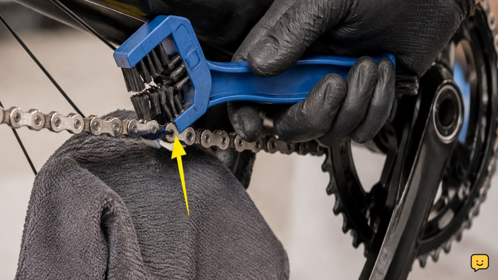 Firm brush scrubbing the rollers and side plates of a bicycle chain