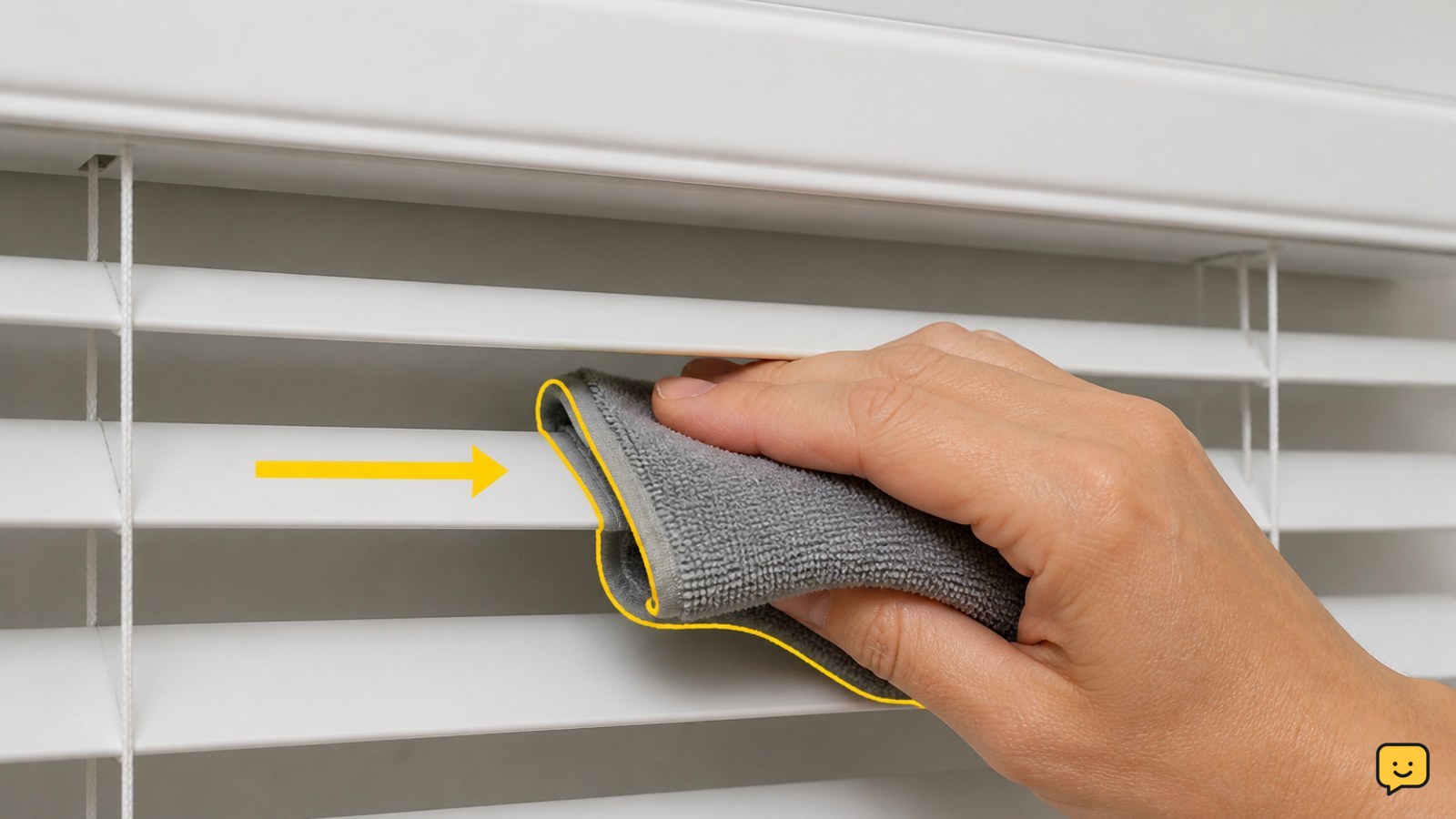 Wringing a microfiber cloth nearly dry before wiping a horizontal blind slat