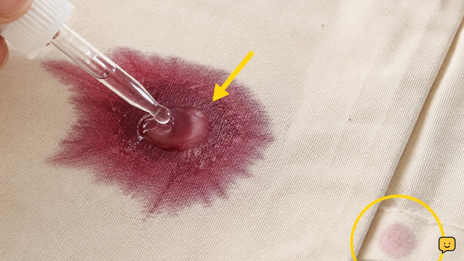 A small amount of stain treatment being applied to a wine mark on washable fabric beside a hidden-area test spot