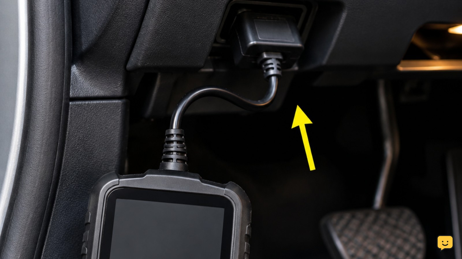 OBD-II scanner plugged into the diagnostic port beneath a car dashboard