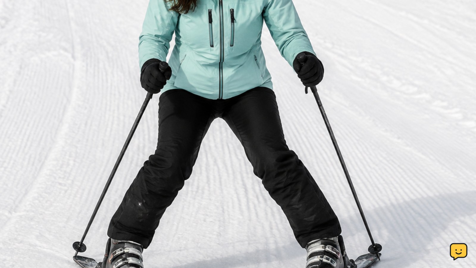 Beginner skier demonstrating a snowplough wedge with ski tips closer together and tails apart