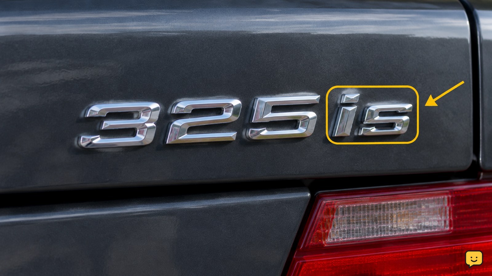 Close-up of an older BMW model badge ending in is