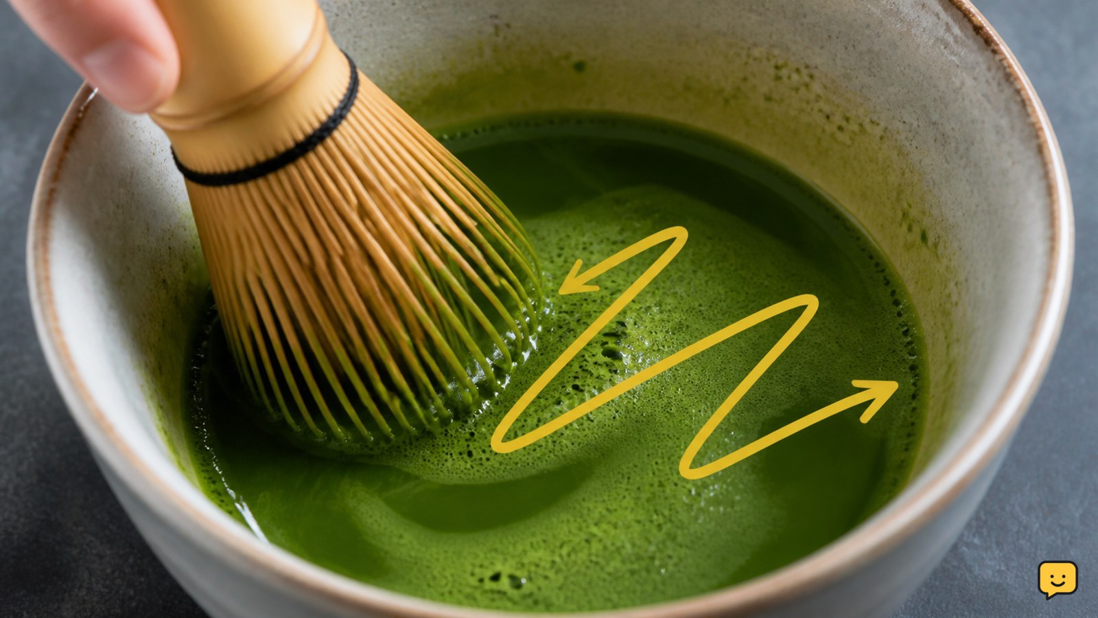 Sifted matcha being whisked with warm water into a smooth green concentrate